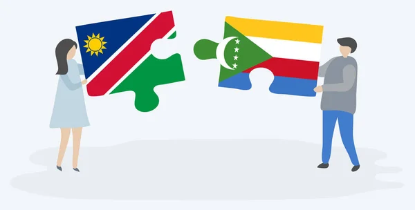 Pareja Sosteniendo Dos Piezas Rompecabezas Con Banderas Namibia Comora Namibia — Vector de stock