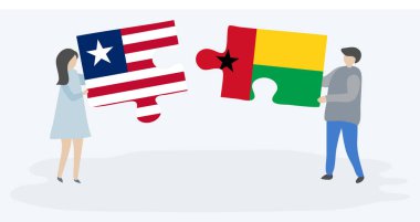 Liberya ve Bissau-Gine bayrakları ile iki bulmaca parçaları tutan çift. Liberya ve Gine-Bissau ulusal sembolleri birlikte.