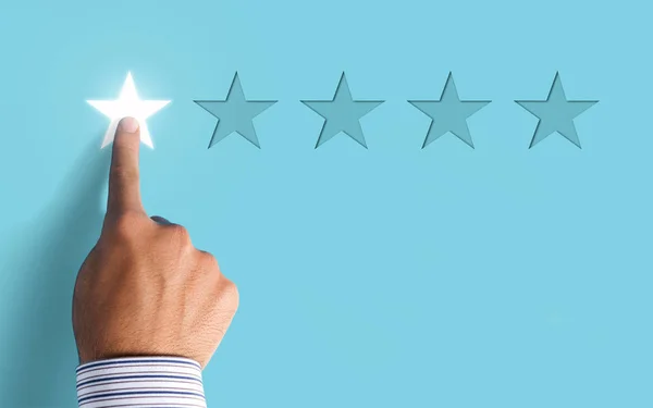 Hand choosing 1 star rating on blue background - negative feedback concept