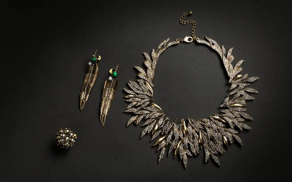 Nature inspired jewelry set on dark background