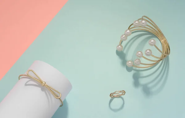 Pulsera de perlas doradas y anillo de oro sobre fondo de color pastel con espacio para copiar — Foto de Stock