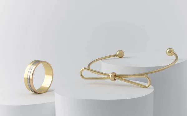 Złoty łuk kształt bransoletka i potrójny pierścień na białych cylindrach z kopią przestrzeni — Zdjęcie stockowe