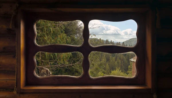 View of mountains from wooden traditional hut window — Stock Photo, Image
