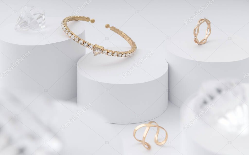 Golden bracelet and rings on white cylinders