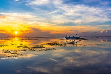 Sunrise, yansımalar su, Sanur, Bali, Endonezya, 21 Nisan 2018 adlı bir Endonezyalı balıkçı teknesi