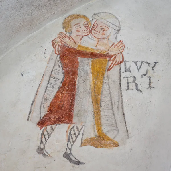 Lust, one of the mortal sins. Man and woman embracing, an ancient gothic mural in Kirkerup public church, Denmark, July 3, 2018,