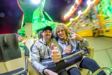 İki adam bir karıncaya eğlence parkında binmek.