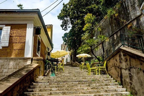 Tables of a cafe on the stairs of the old city in Herceg Novi