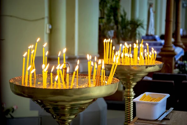 Church candles burn inside the temple