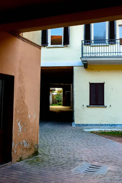 Narrow street between italian houses in old town , Toning.