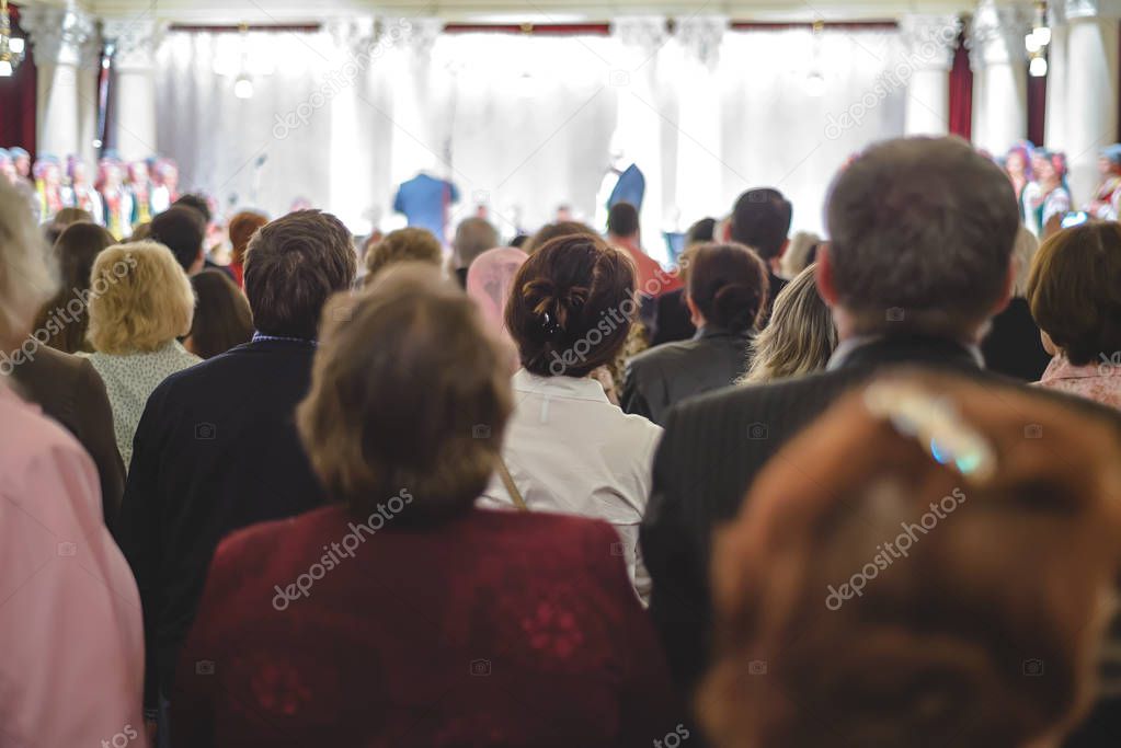 People are sitting at a concert.