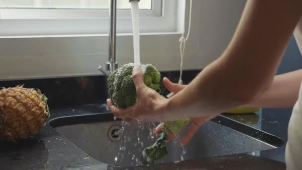 Close-up dames handen wassen broccoli op binnenlandse keuken in slow motion — Stockvideo