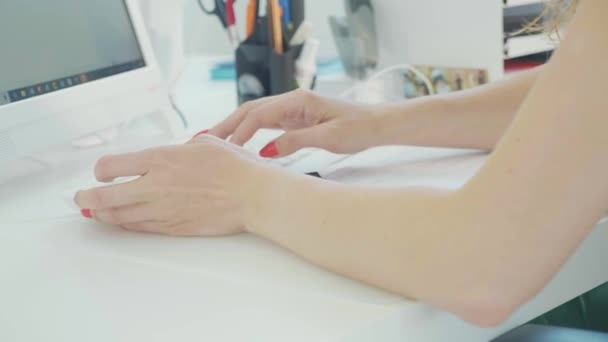Крупный план женской руки, печатающей на клавиатуре компьютера в современном офисе — стоковое видео