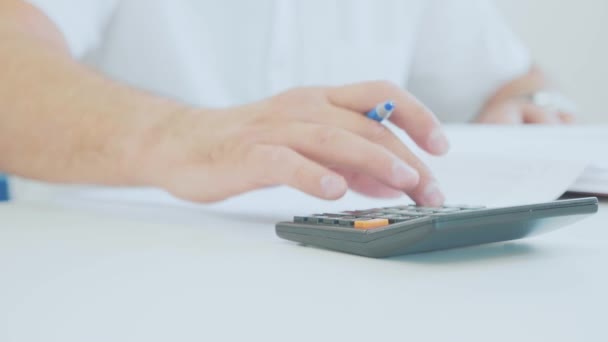 Businessman hand working with finances documents and using calculator in office — Stock Video