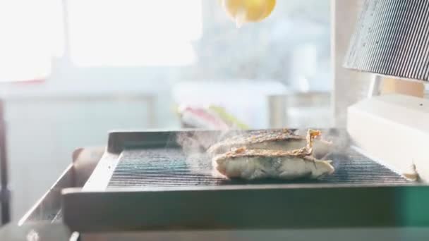 A steak of fresh fish is fried on a hot grill with aroma and smoke — Stock Video