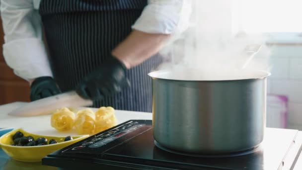 난로에 김이 냄비의 근접 때 레몬을 자르고 하는 요리사 — 비디오