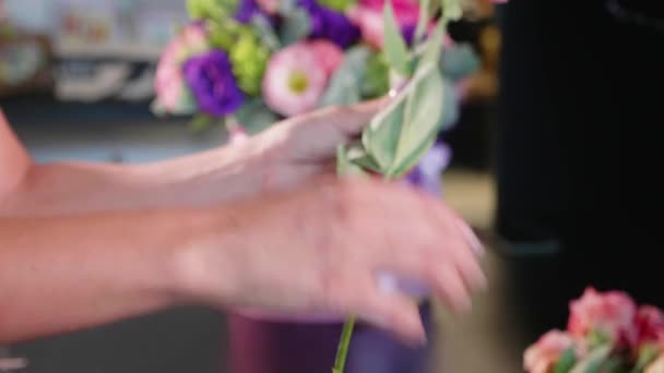 Bloemist meisje maakt een floral doos in de salon van een bloem, close-up — Stockvideo