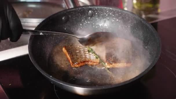 Pan-fried fish, Two pieces of loban fillet on the steaming frying pan. — Stock Video