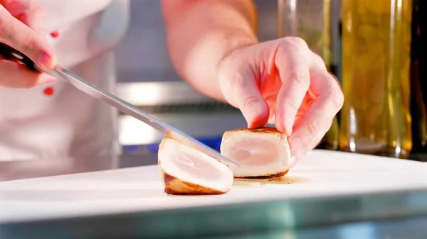 Chef is garnishing tuna fish fillet at restaurant kitchen in slow motion