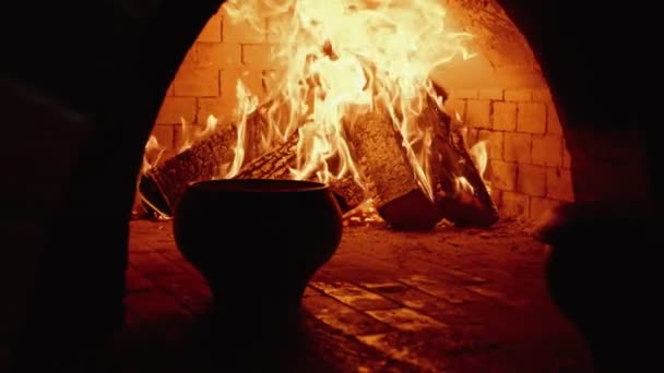 Traditional Russian stove with cooking food on wood in crock — Stock Video
