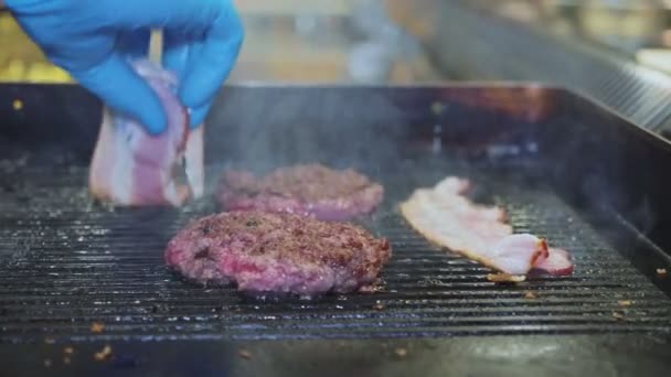 Close-up grilling burger cutlet and ham on friying surface — Stok Video
