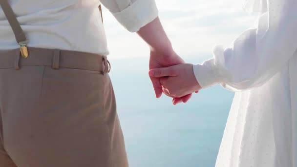 Close-up of two lovers joining hands and turning face to face each other. — Stock Video