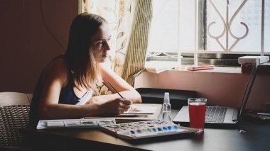 Genç kadın bir ders suluboya evde online boyama içinde geçer