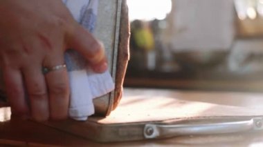 Fırıncı kalıp üzerinden sıcak ekmek ortaya çıkarır ve masanın üzerine koyar.