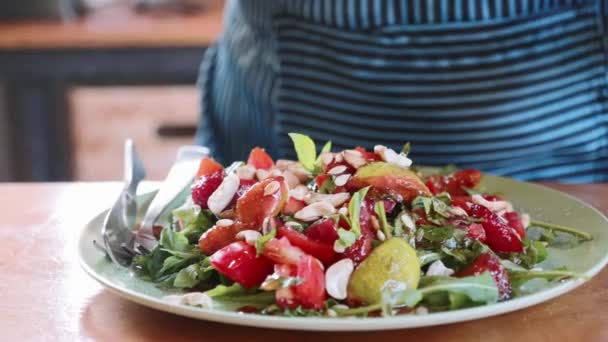 Close-up de cozinheiro feminino que serve salada doce exótica com legumes e frutas — Vídeo de Stock