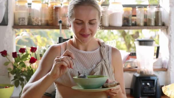 Young happy woman tasting just preparing food in the kitchen. — Stock Footage Young happy woman tasting just preparing food in the kitchen. Stock Footage