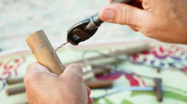 Komuta sizde oturur plaj ve yapım flüt üzerinde eller tarafından yakın çekim.