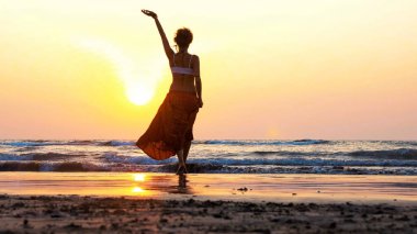 gün batımında sahilde dans genç kız silüeti