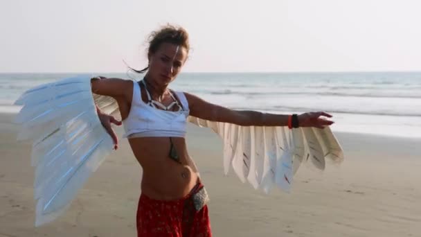 Young girl with angel wings dancing at sunset — Stock Video