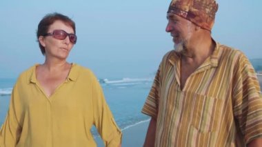 Sahilde yürümeye ve konuşmaya, steadicam atış üst düzey çift