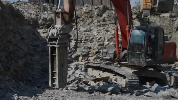En kryp grävmaskin hydraulisk stenhammare är Breakin stenig jord. Närbild. — Stockvideo
