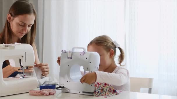 A mother and a daughter are spending time at sewing and talking. Panoramic view. — Stock Video