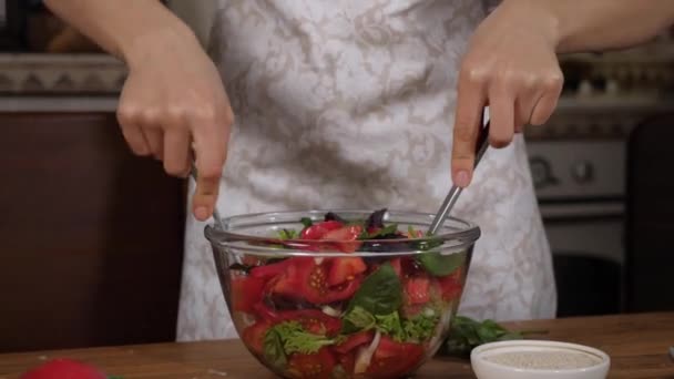 Жінка змішує свіжий салат у класі, крупним планом . — стокове відео