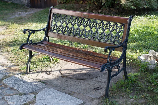 Sitting bench standing on grass on a sunny spring