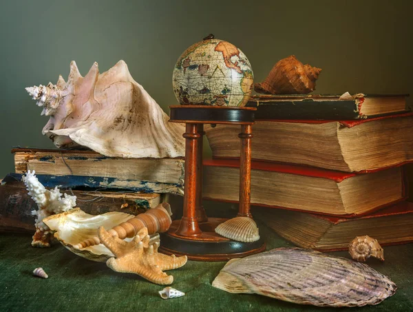 Still life with sea shells, books and a globe. Vintage. Retro.