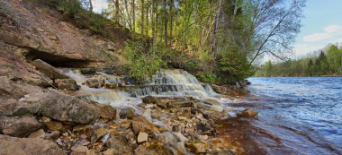 Bir rocky nehir kıyısında pitoresk bir şelale büyük formatlı Panoraması