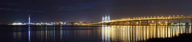 Night wide-Angle panorama of the Western high-speed Diameter, cable-stayed bridge, tower and port in St. Petersburg clipart