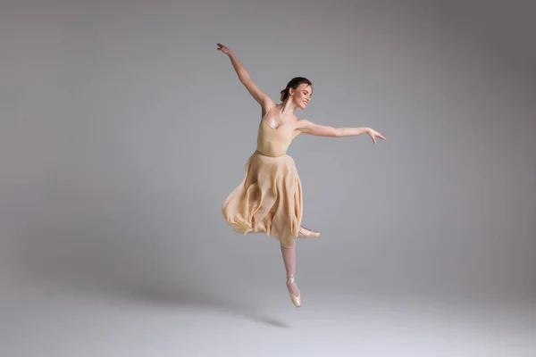 ¡Tan ligero como una pluma! Joven atractiva elegante bailarina suave bailando en la actuación de arte en el fondo aislado . —  Fotos de Stock