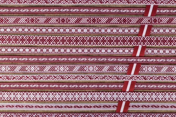 Latvian national style background with ornamented ribbons