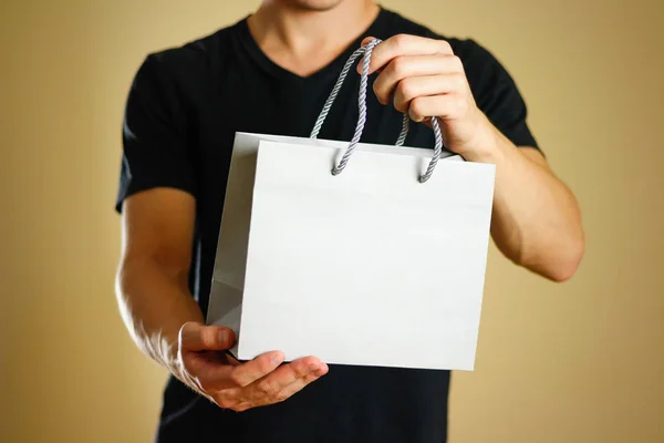 Man Holding Gray Gift Bag Close Isolated Background — Stock Photo, Image