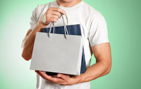 Man Holding Blue Grey Gift Bags Close Isolated Background — Stock Photo, Image
