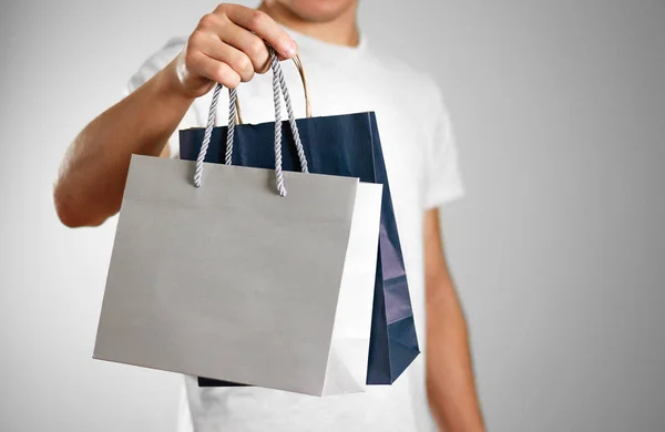 Man Holding Blue Grey Gift Bags Close Isolated Background — Stock Photo, Image