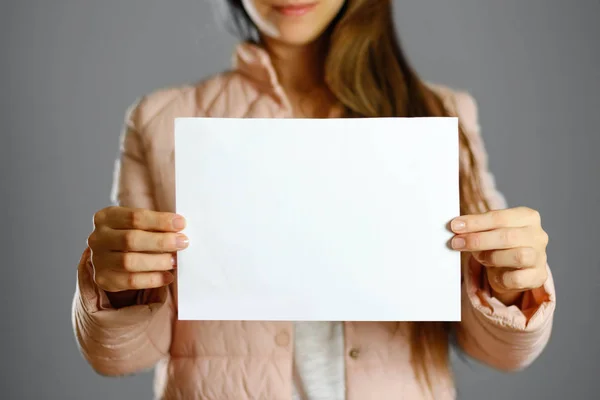 Woman Warm Winter Jacket Holding White Leaflet Blank Paper Close — Stock Photo, Image