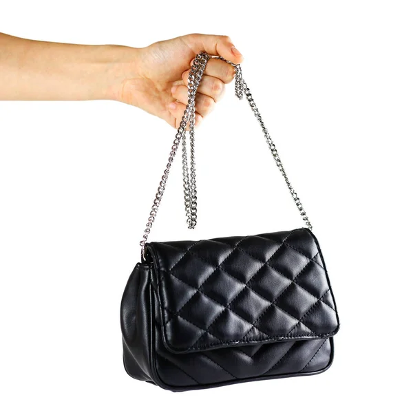 小さな黒い革女性のハンドバッグを持っている手 クラッチ クローズ アップ 白い背景に分離 — ストック写真