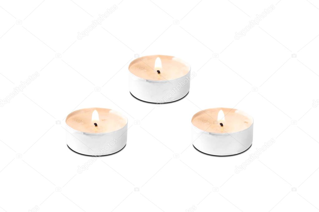 Three burning candles. Close up. Isolated on white background.