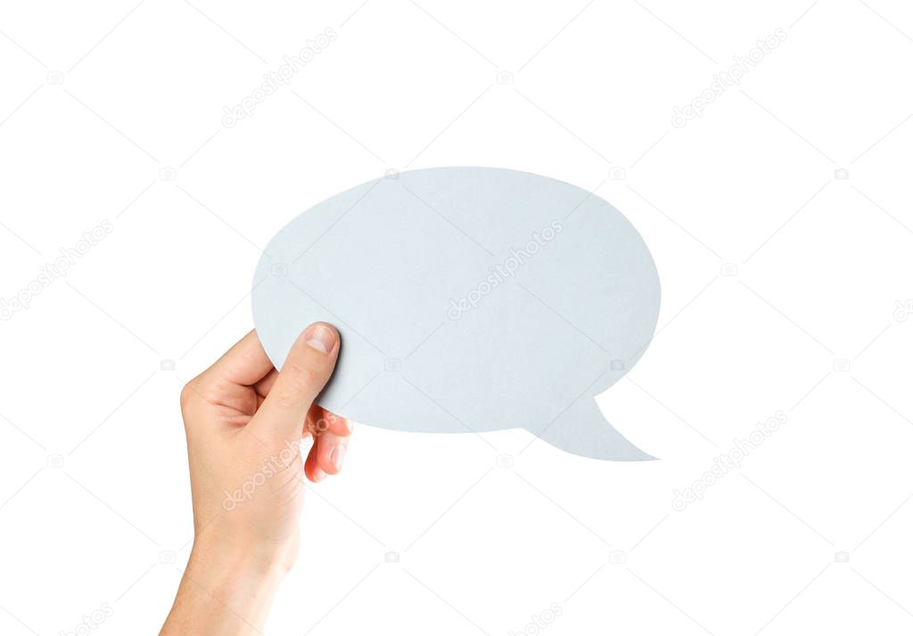 Hand holding an empty speech bubble. Close up. Isolated on white background.